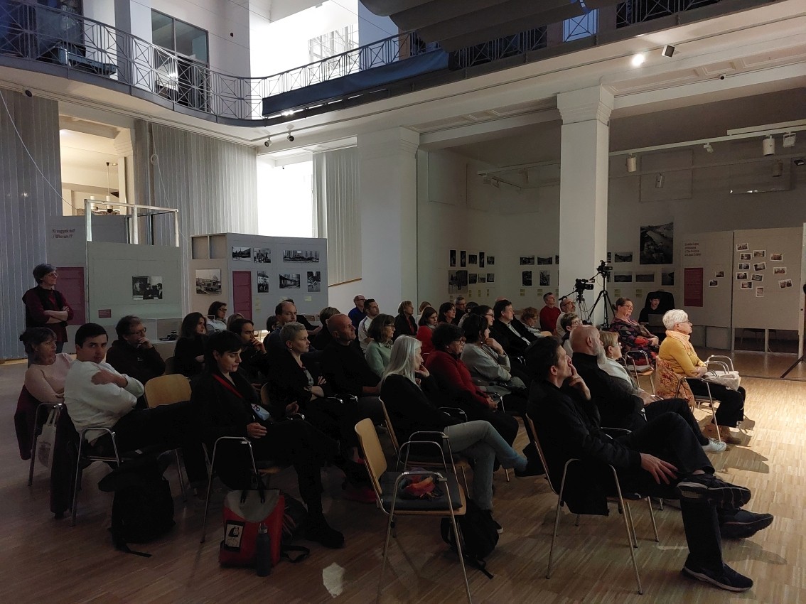 Men in prison uniforms at a court hearing