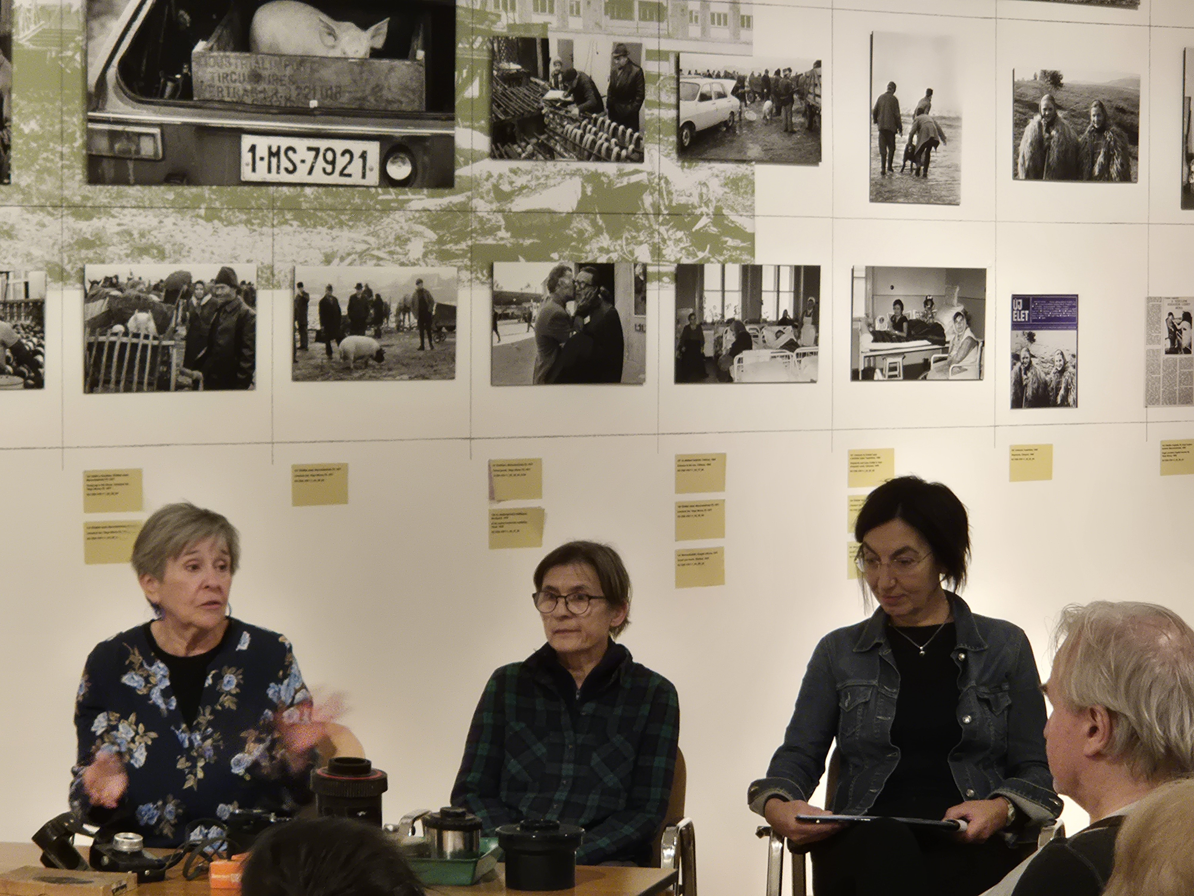 A pig in an old-fashioned cart, with people standing around it