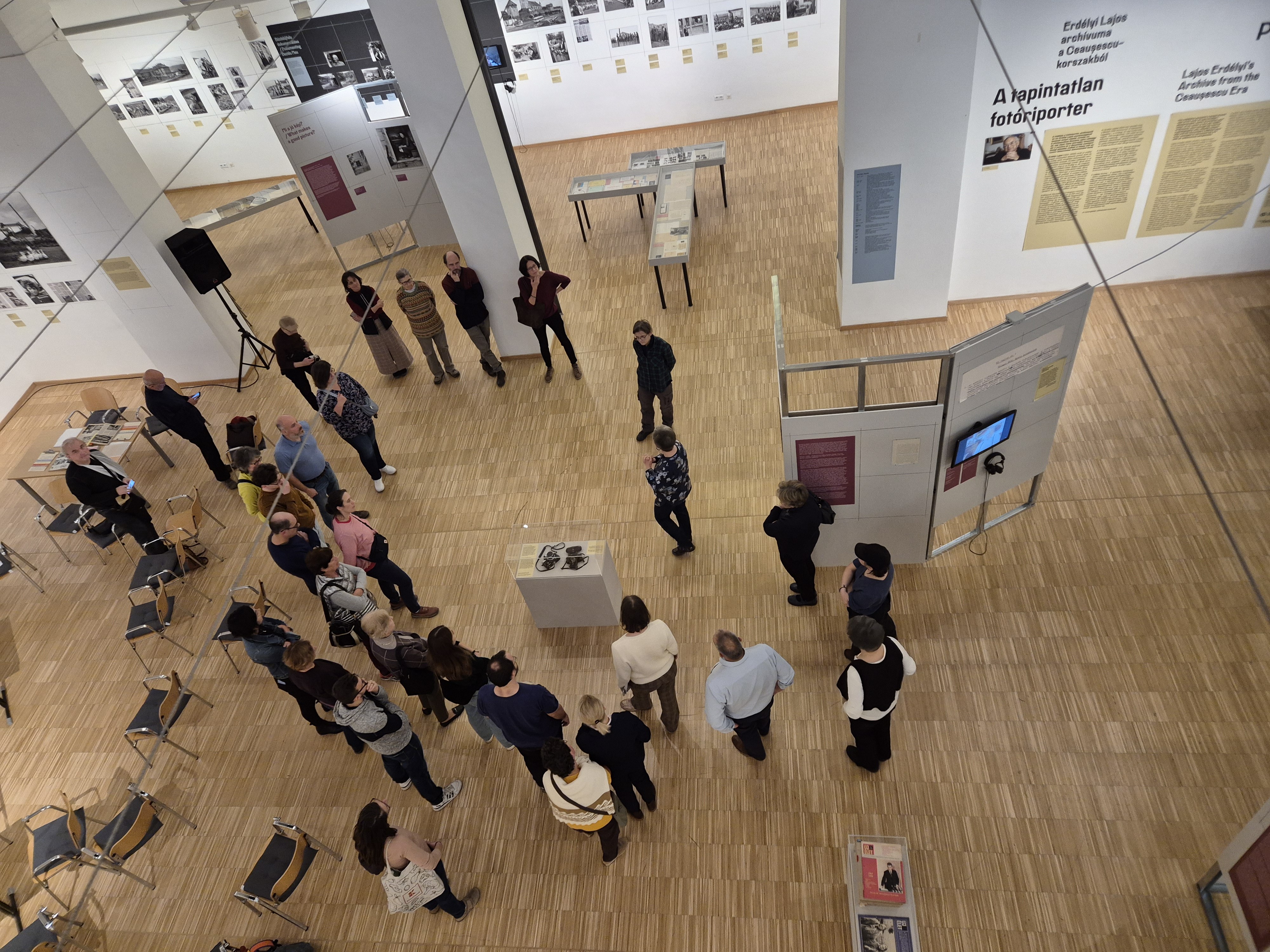 A pig in an old-fashioned cart, with people standing around it