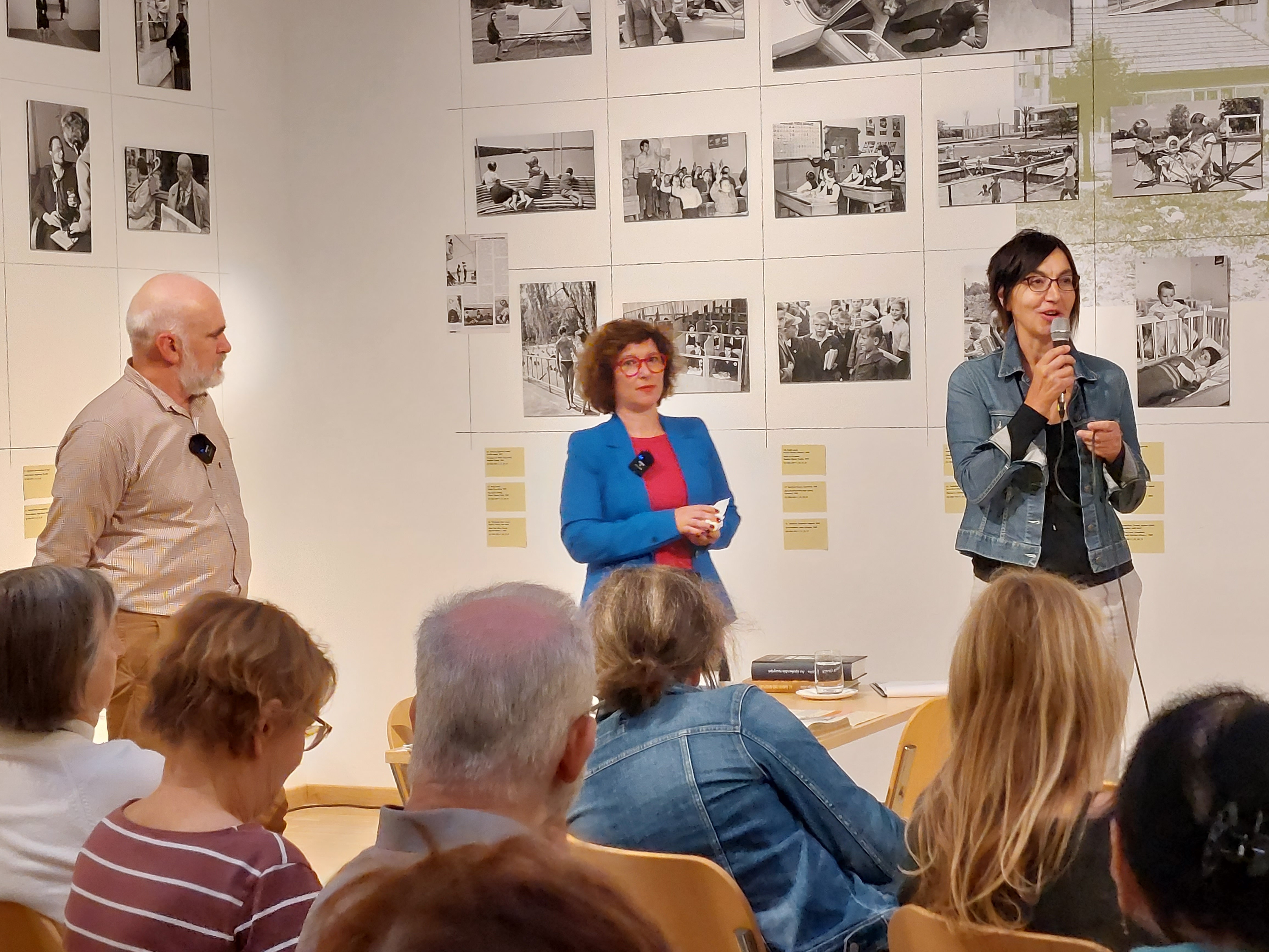 Children playing at a playground in front of a factory building
