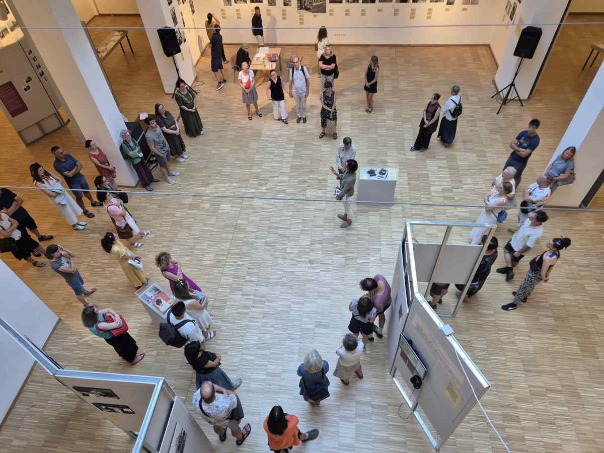 Curators Lenke Sziágyi and Zsuzsa Zádori standing in front of the exhibition.