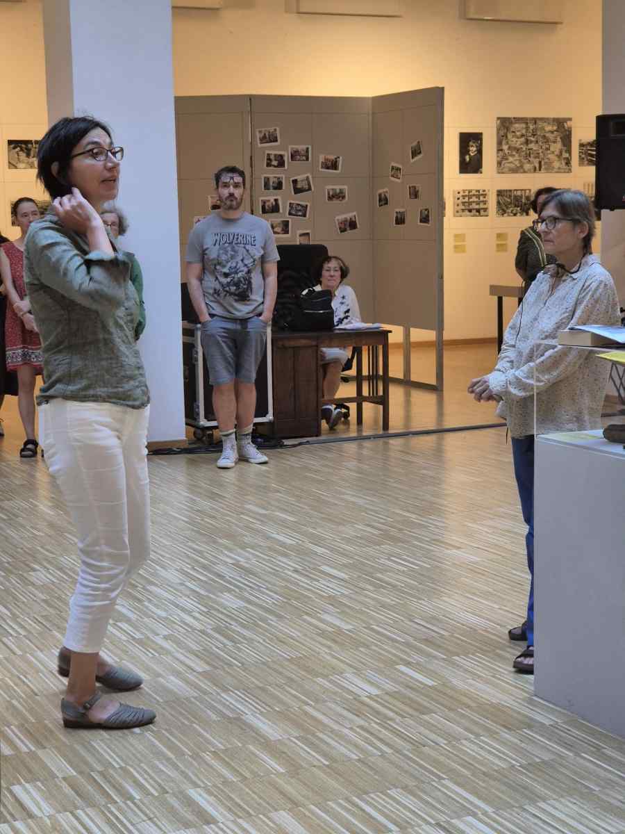 Curators Lenke Sziágyi and Zsuzsa Zádori standing in front of the exhibition.