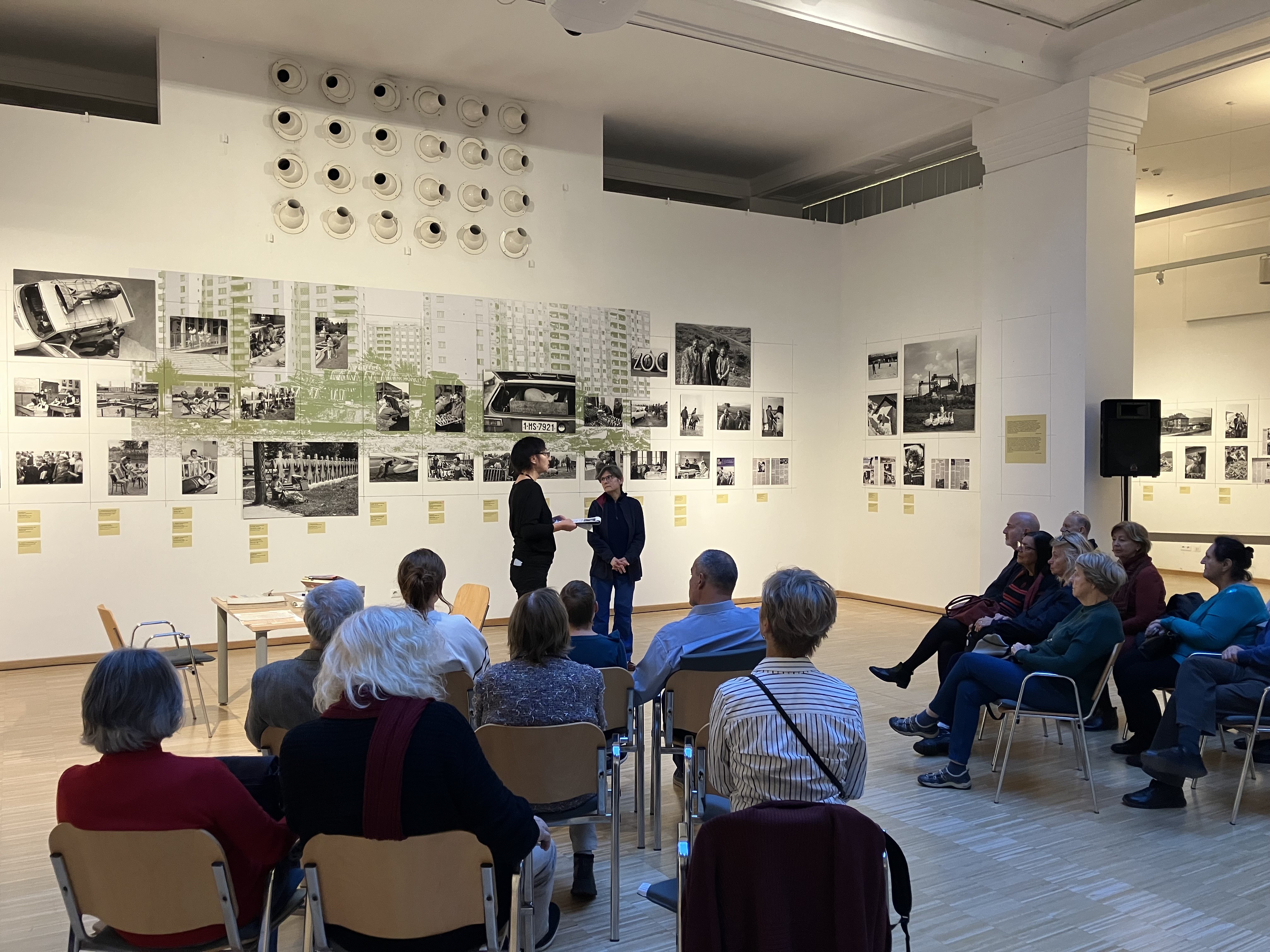 Curators Lenke Sziágyi and Zsuzsa Zádori standing in front of the exhibition.