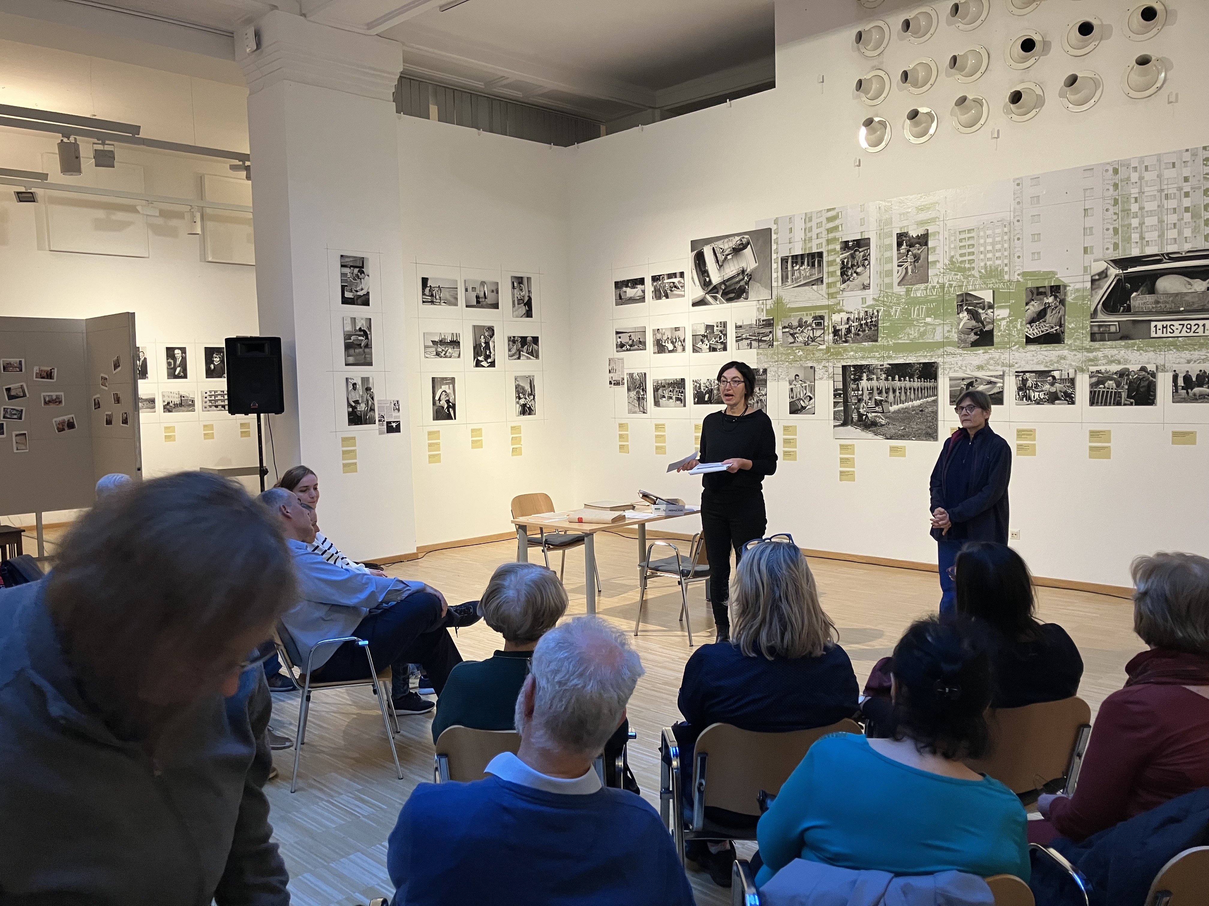 Curators Lenke Sziágyi and Zsuzsa Zádori standing in front of the exhibition.