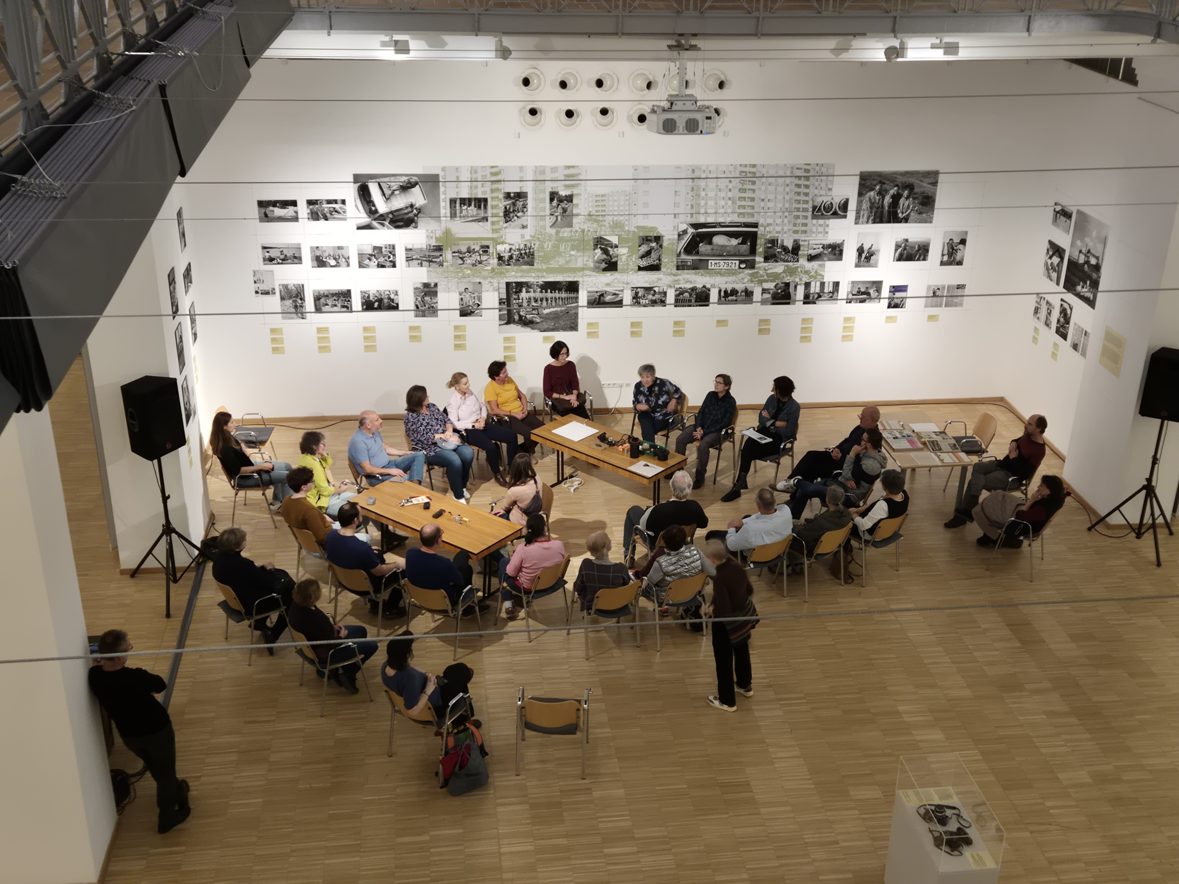 A pig in an old-fashioned cart, with people standing around it